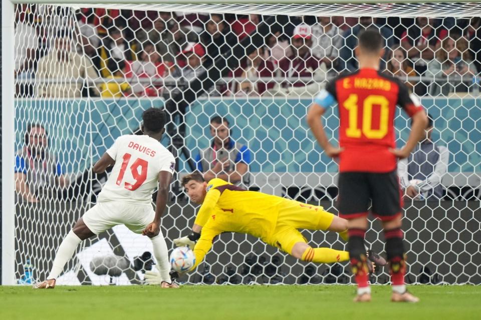 Belgium goalkeeper Thibaut Courtois makes a save on a penalty kick from Canada forward Alphonso Davies during the World Cup group F football match between Belgium and Canada, at the Ahmad Bin Ali Stadium in Doha, Qatar, Wednesday, Nov. 23, 2022. (Nathan Denette/The Canadian Press via AP)