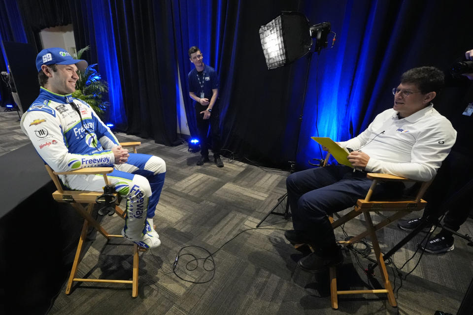 Daniel Suarez, left, takes part in an interview during NASCAR Daytona 500 auto racing media day at Daytona International Speedway, Wednesday, Feb. 14, 2024, in Daytona Beach, Fla. (AP Photo/John Raoux)