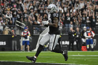 Las Vegas Raiders tight end Darren Waller runs into the end zone to score on a 25-yard pass during the first half of an NFL football game between the New England Patriots and Las Vegas Raiders, Sunday, Dec. 18, 2022, in Las Vegas. (AP Photo/David Becker)
