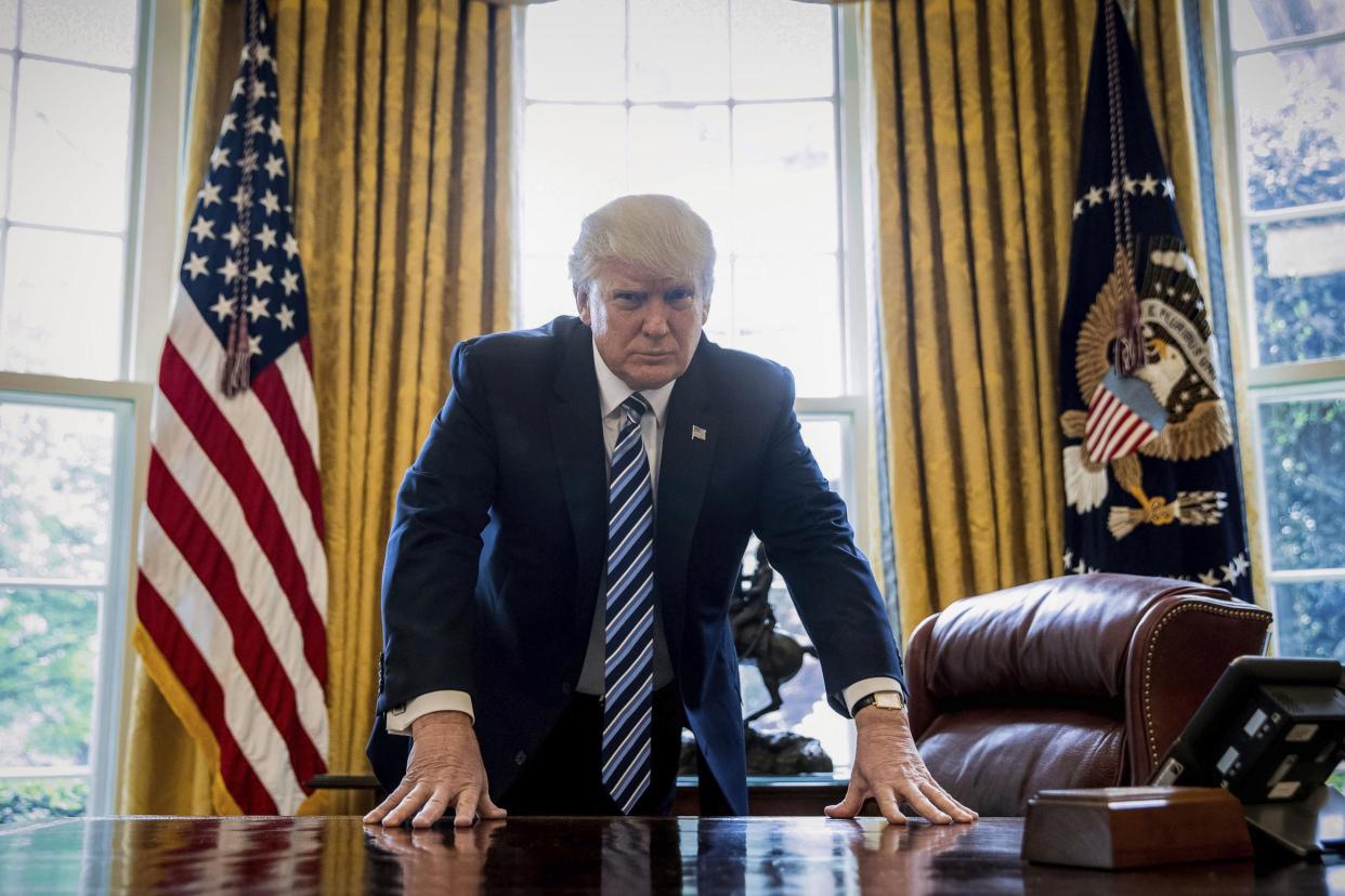 President Donald Trump poses for a portrait in the Oval Office: AP