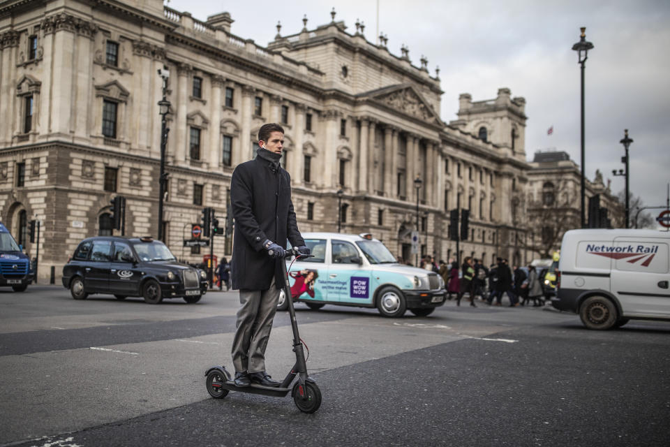 LONDON, ENGLAND - JANUARY 9: A man passes past Parliament Square on an electric scooter on January 9, 2019 in London, England. In the UK, electric scooters and similar powered transporters are still classified as 'motor vehicles,' subject to the same regulations. This makes them illegal to operate in pedestrian areas and bicycle lanes, and imposes strict licensing requirements on potential road use. Despite the current prohibitive regulations, many commuters have turned towards scooters as an alternative mode of travel. (Photo by Dan Kitwood/Getty Images)