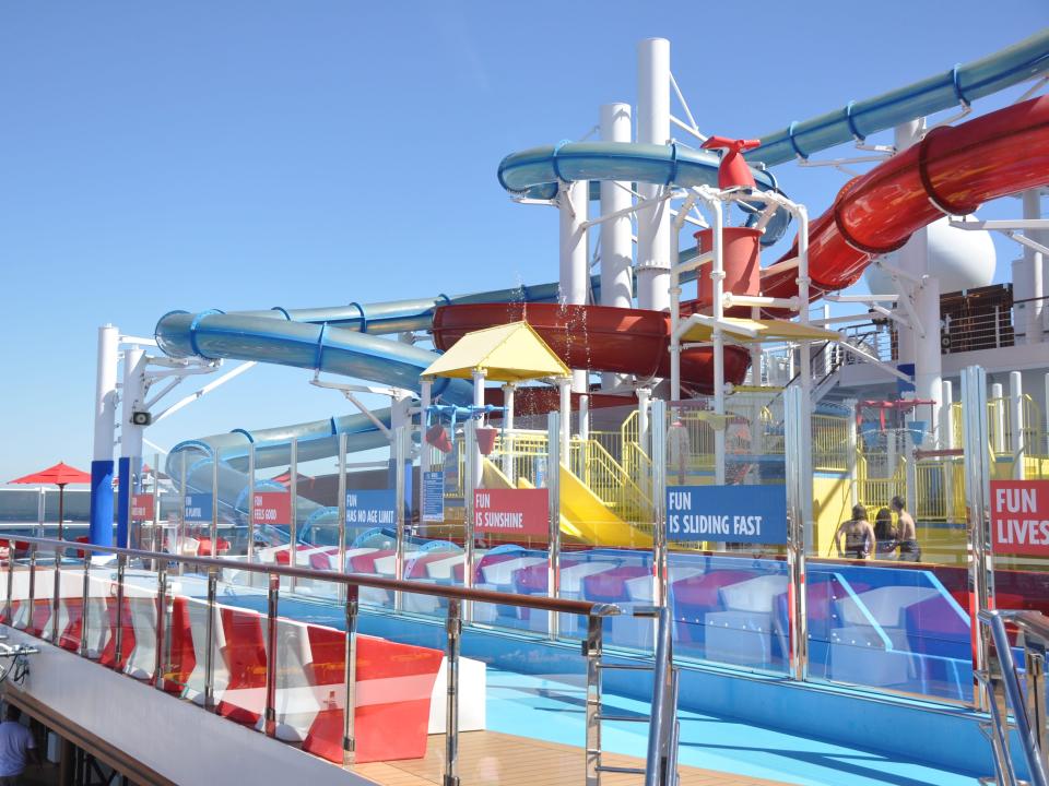 Colorful waterslides on the top deck of a cruise ship.