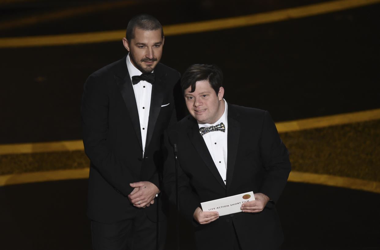 Shia LaBeouf, left, and Zack Gottsagen present the award for best live action short film at the Oscars on Sunday, Feb. 9, 2020, at the Dolby Theatre in Los Angeles. (AP Photo/Chris Pizzello)