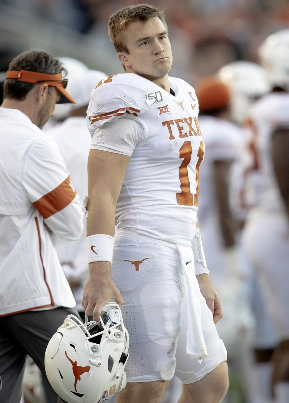 Texas quarterback Sam Ehlinger (11) stands on the sideline during an NCAA college football game against Baylor on Saturday, Nov. 23, 2019, in Waco, Texas. (Nick Wagner/Austin American-Statesman via AP)