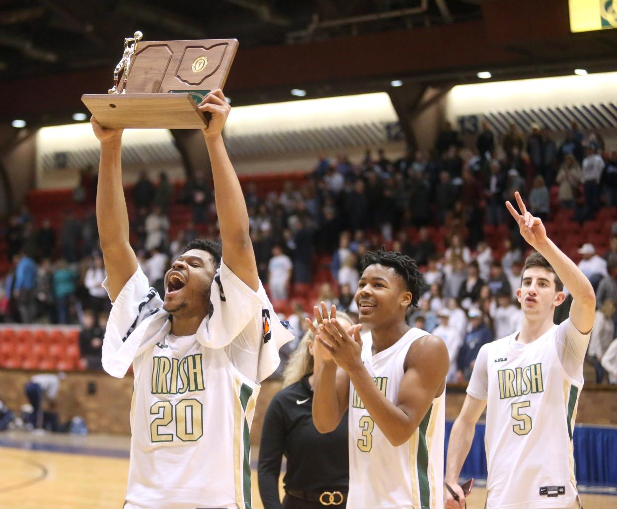 Ramar Pryor, 20, Clinton Thomas III, 3, and Ethan Connery, 5, of Akron St. Vincent-St. Mary celebrate their victory over Louisville in the DII regional final at the Canton Memorial Civic Center on Saturday, March 12, 2022.