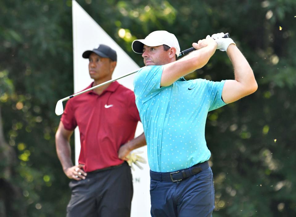 Rory McIlroy hits his tee shot as Tiger Woods looks on on the 8th hole during the final round of The 2020 Northern Trust golf tournament at TPC of Boston.