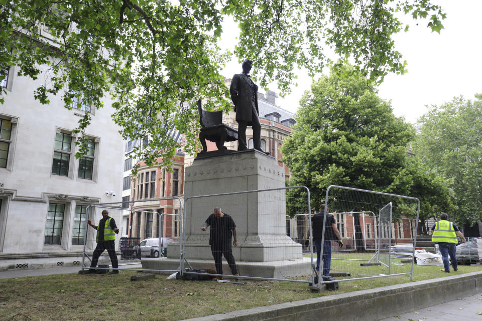 Barriers are erected around the statue of former US President Abraham Lincoln in Parliament Square, London, Friday June 12, 2020. A raft of Black Lives Matter protests sparked by the death of George Floyd, who was killed recently while in police custody in the US city of Minneapolis, has prompted authorities to protect statues of historical figures who had links to the slave trade, and a wider debate about issues relating to Britain's colonial past. (Aaron Chown/PA via AP)