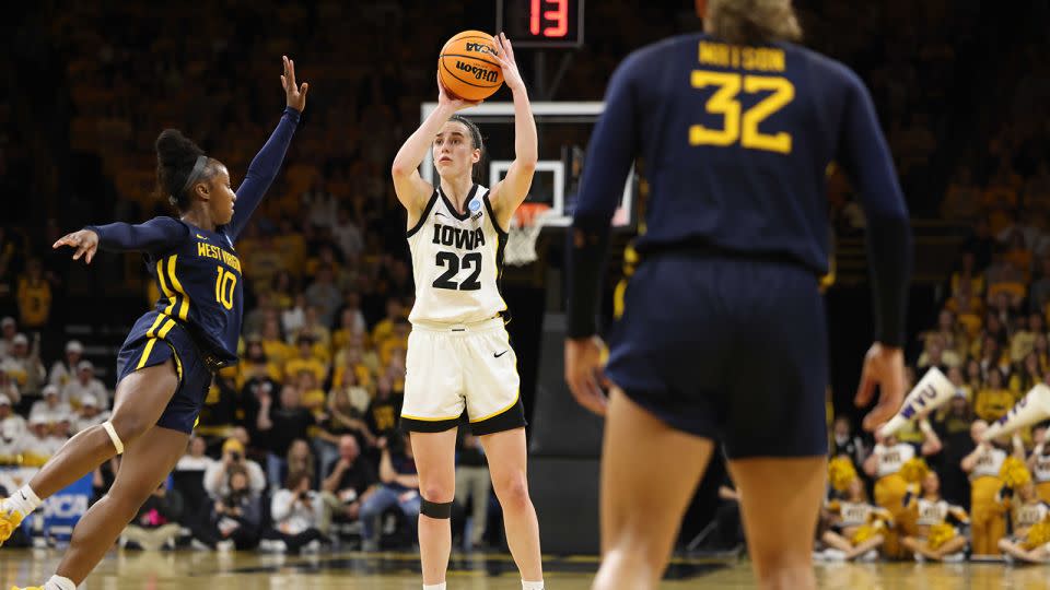 Clark shoots as West Virginia's Jordan Harrison, No. 10, defends during Monday's second-round NCAA tournament game. - Rebecca Gratz/NCAA/Getty Images
