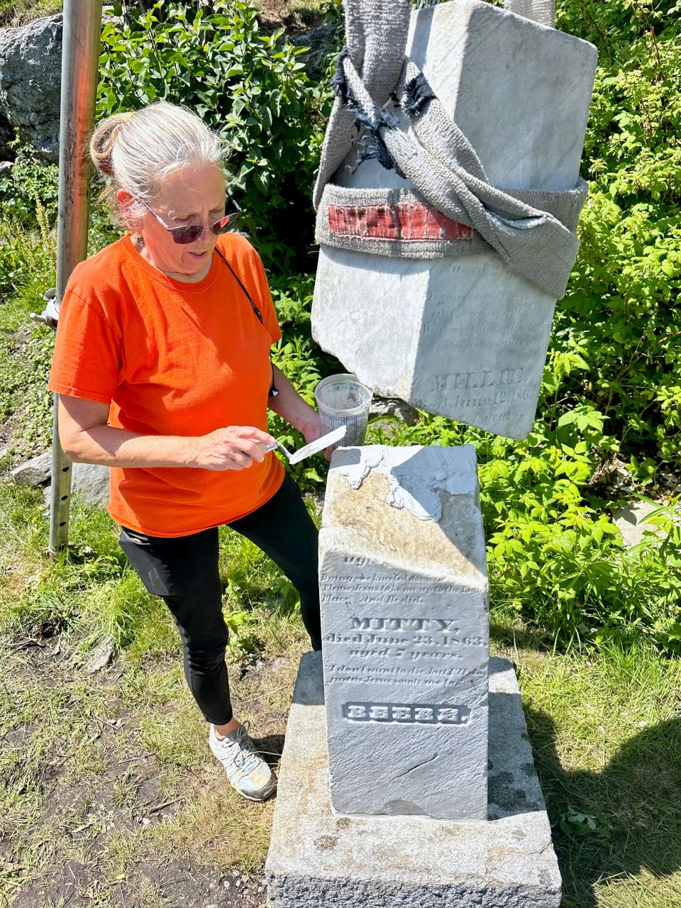 TaMara Conde, who has been restoring gravestones for 25 years, joined ISHRA volunteers on Star Island to repair stones in a Civil War era cemetery there.