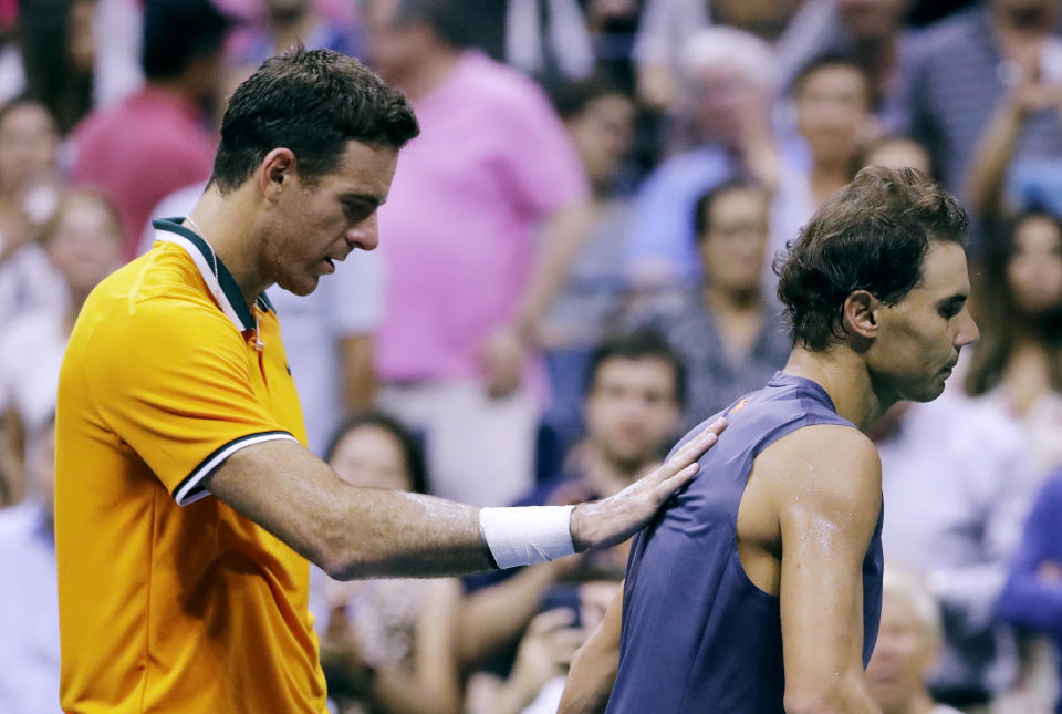 Rafael Nadal, of Spain, walks away from Juan Martin del Potro, of Argentina, after Nadal retired from a match against del Potro during the semifinals of the U.S. Open tennis tournament, Friday, Sept. 7, 2018, in New York. (AP Photo/Seth Wenig)