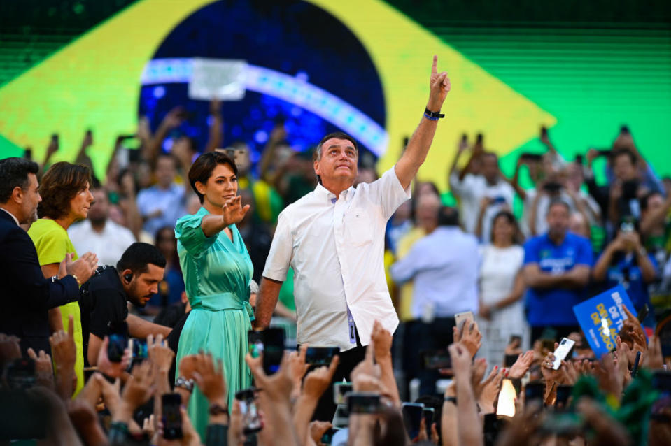 Jair Bolsonaro, Brazil's President, center, and first lady Michelle Bolsonaro attend the National Convention to formalize his candidacy for a second term, at Maracanazinho Gymnasium in Rio de Janeiro, on Sunday, July 24, 2022.<span class="copyright">Andre Borges/Bloomberg via Getty Images</span>