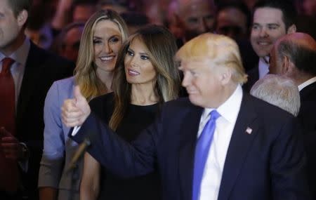 Republican U.S. presidential candidate Donald Trump is joined by his wife Melania (C) at his five state primary night event in New York City, U.S., April 26, 2016. REUTERS/Carlo Allegri