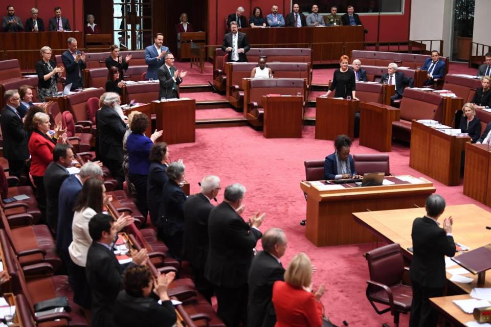 Chastised: Senators from both sides join in applauding Attorney-General George Brandisfor his comments (EPA)