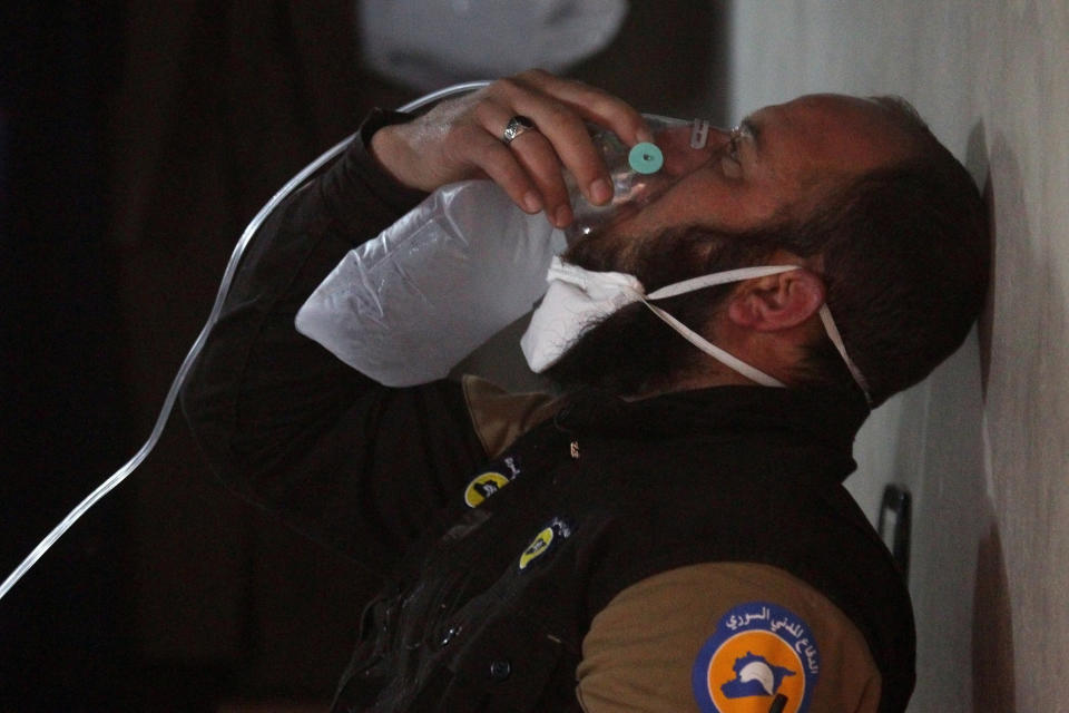 A civil defence member breathes through an oxygen mask, after what rescue workers described as a suspected gas attack in the town of Khan Sheikhoun in rebel-held Idlib, Syria April 4, 2017.&nbsp;