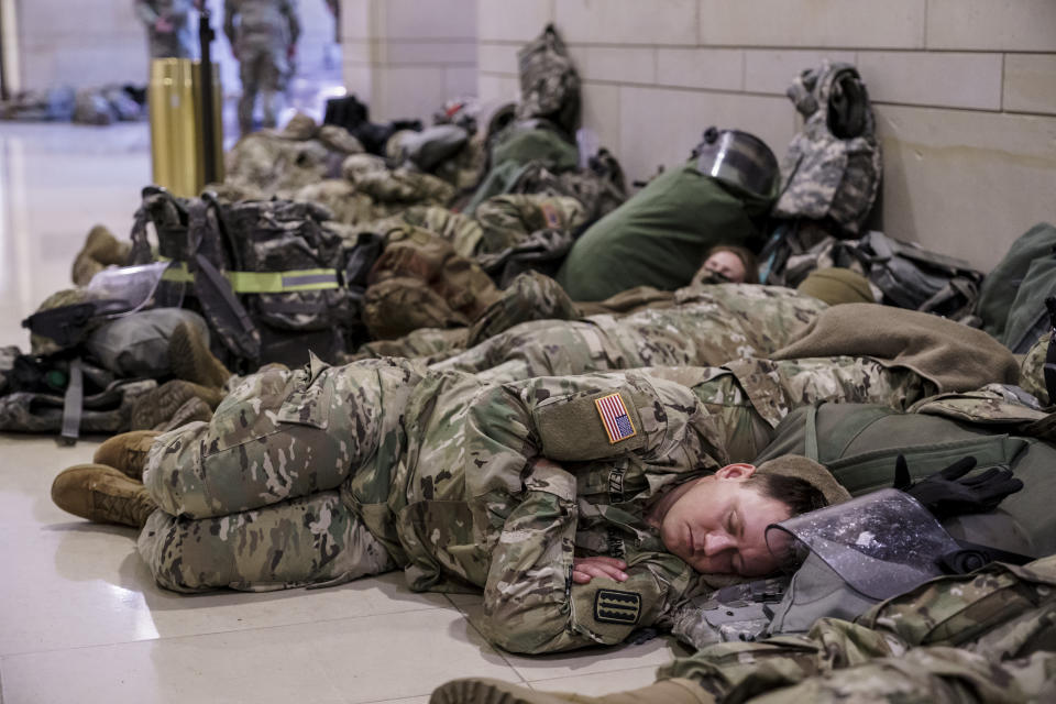 Hundreds of National Guard troops hold inside the Capitol Visitor's Center to reinforce security at the Capitol in Washington, Wednesday, Jan. 13, 2021. The House of Representatives is pursuing an article of impeachment against President Donald Trump for his role in inciting an angry mob to storm the Capitol last week. (AP Photo/J. Scott Applewhite)