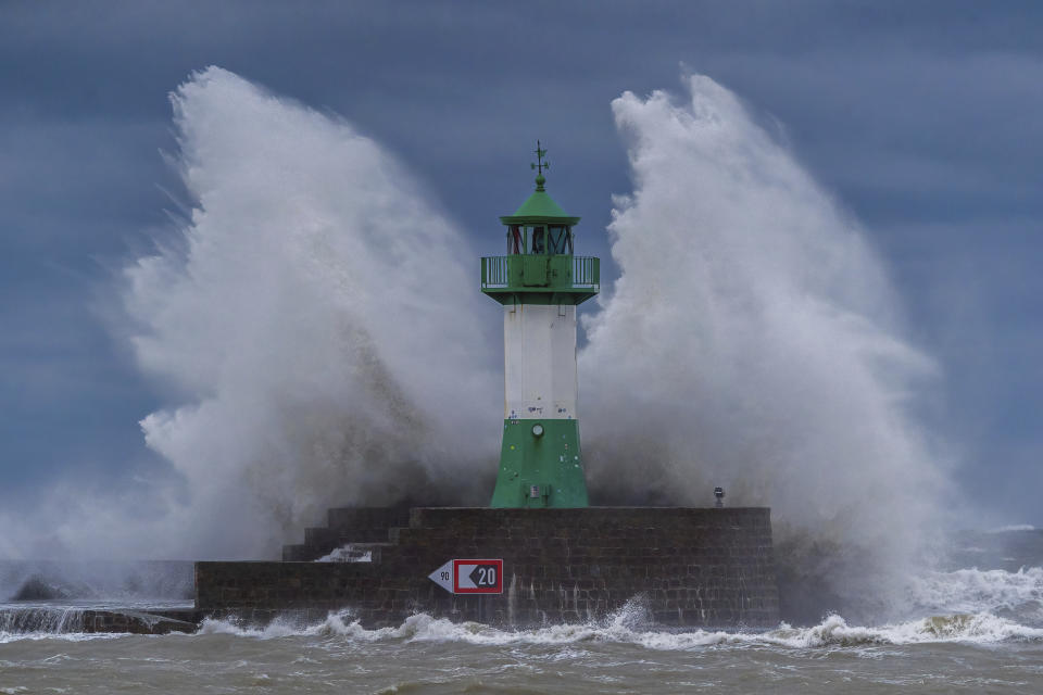 Waves from the Baltic Sea lash against the lighthouse on the eastern pier during a severe storm depression, in Sassnitz, Germany, Oct. 20, 2023. Due to the storm low, streets and shore areas on the Baltic Sea coast have been flooded by high water. A severe storm surge is expected in the north for the rest of the day. (Georg Moritz/dpa via AP)