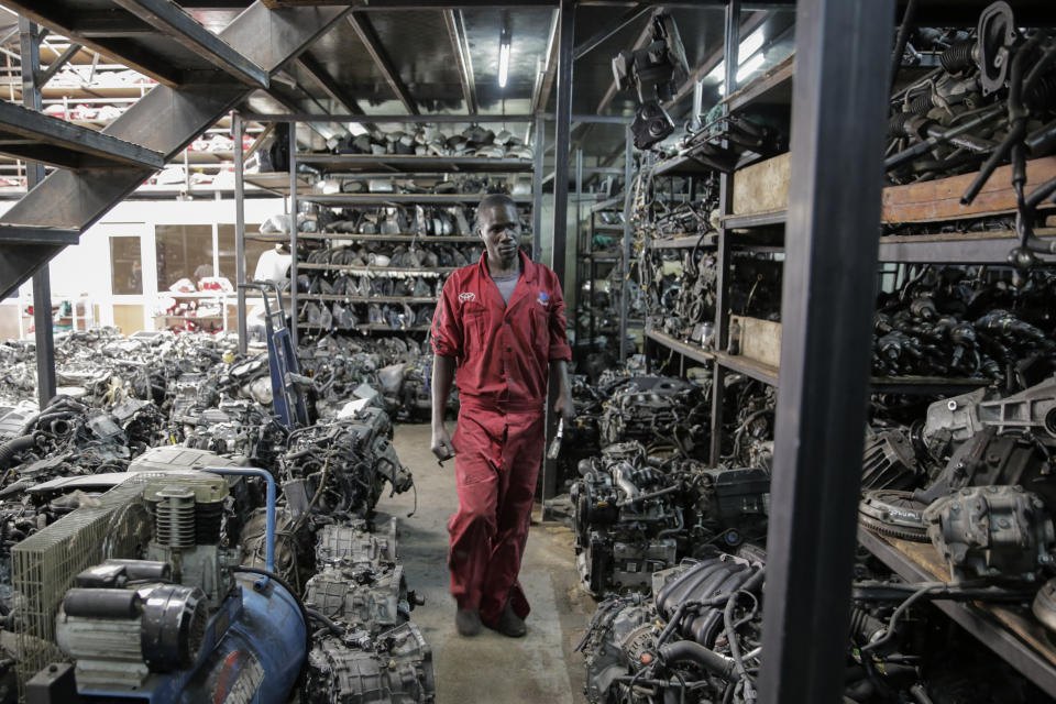 A worker looks for items at a secondhand car parts warehouse in the industrial area of the capital Nairobi, Kenya, Friday, Oct. 7, 2022. As the value of the U.S. dollar soars, other currencies around the world are sinking by comparison. (AP Photo/Brian Inganga)
