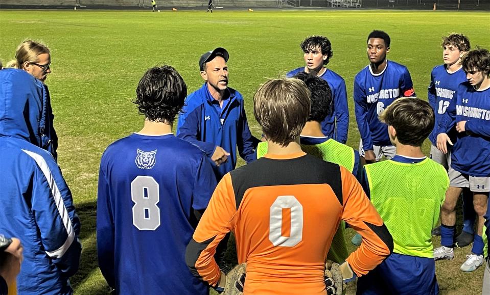 Booker T. Washington head coach Felipe Lawall instructs his team at the second water break during the team's Region 1-5A quarterfinal against Menendez on Feb. 8, 2023 from Sherman L. Robinson Stadium.