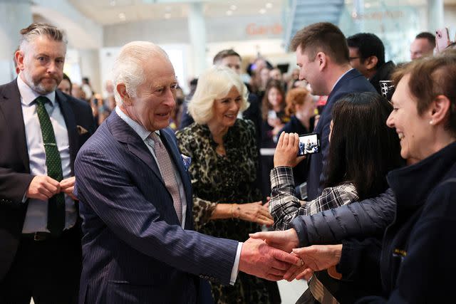 <p>SUZANNE PLUNKETT/POOL/AFP via Getty Images</p> King Charles and Queen Camilla meet staff members at the University College Hospital Macmillan Cancer Centre in London on April 30, 2024.