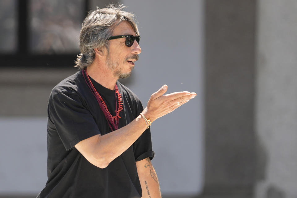 Creative director Pierpaolo Piccioli runs on the catwalk at the end of the Valentino men's Spring Summer 2024 fashion show presented in Milan, Italy, Friday, June 16, 2023. (AP Photo/Luca Bruno)