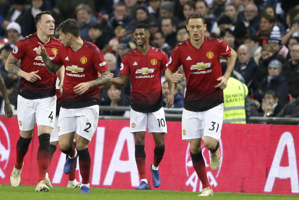 Manchester United's Marcus Rashford, 2nd right, celebrates after scoring the opening goal during the English Premier League soccer match between Tottenham Hotspur and Manchester United at Wembley stadium in London, England, Sunday, Jan. 13, 2019. (AP Photo/Tim Ireland)