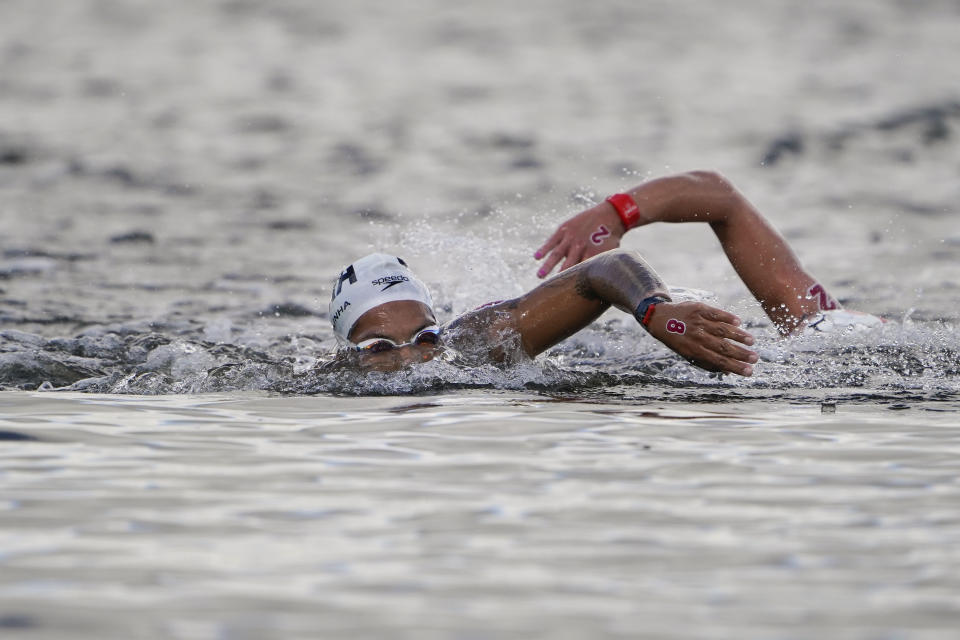 Ana Marcela Cunha, center, of Brazil, and Ashley Twichell, of the United States, compete during the women's marathon swimming competition at the 2020 Summer Olympics, Wednesday, Aug. 4, 2021, in Tokyo, Japan. (AP Photo/Jae C. Hong)