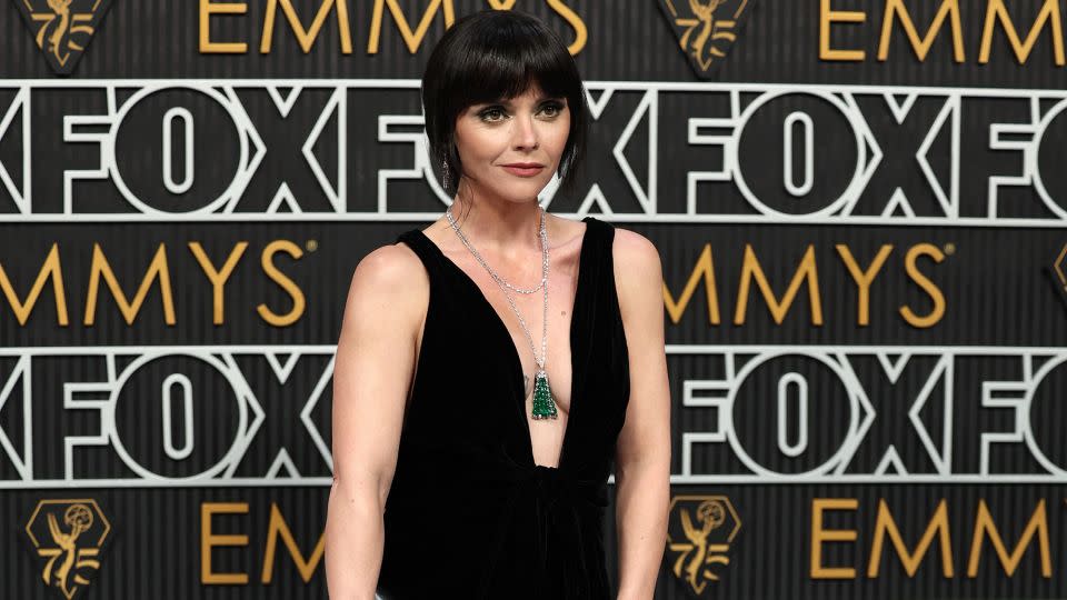 Christina Ricci wore a plunging velvet Saint Laurent dress and jewelry from Martin Katz, including a stunning emerald tassel necklace. - Mike Blake/Reuters