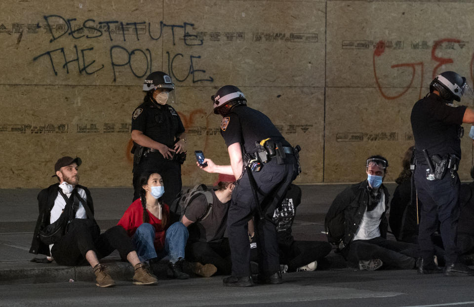 Police arrest a group of people after curfew in New York, Tuesday, June 2, 2020. New York City extended an 8 p.m. curfew all week as officials struggled Tuesday to stanch destruction and growing complaints that the nation's biggest city was reeling out of control night by night. (AP Photo/Craig Ruttle)