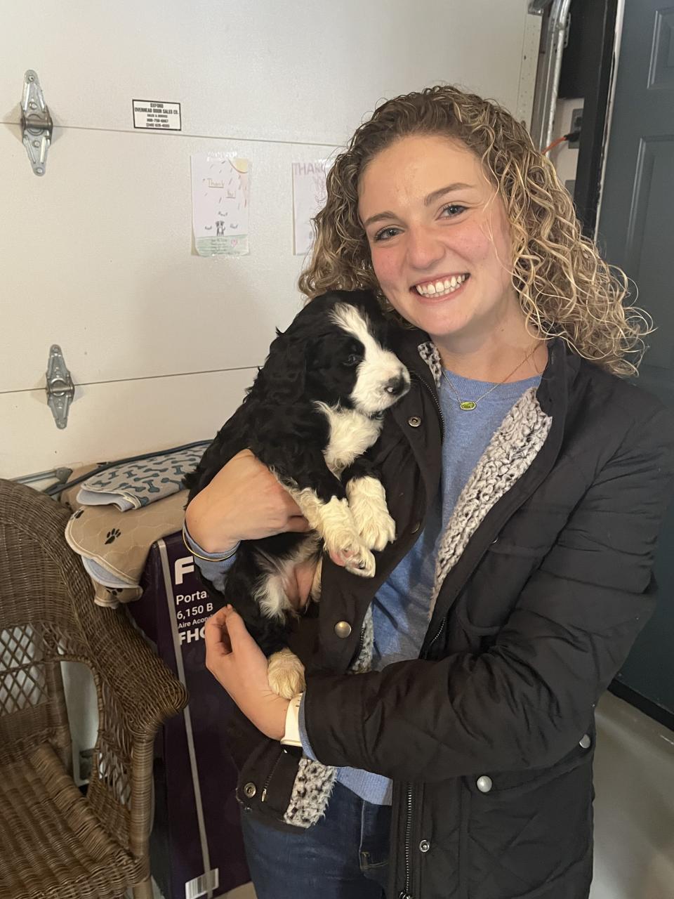 Alexandria "Lexi" Fata with Gracie, a Bernedoodle she says she adopted in order to become a therapy dog for Ann Arbor Public Schools. Fata is now suing after she claims Ann Arbor administrators stole Gracie from her in a battle over ownership.