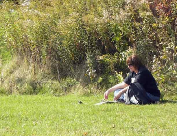 Author and paranormal investigator Kat Tedsen sits on the grounds of Fort Holmes on Mackinac Island in this undated photo running EVP session.