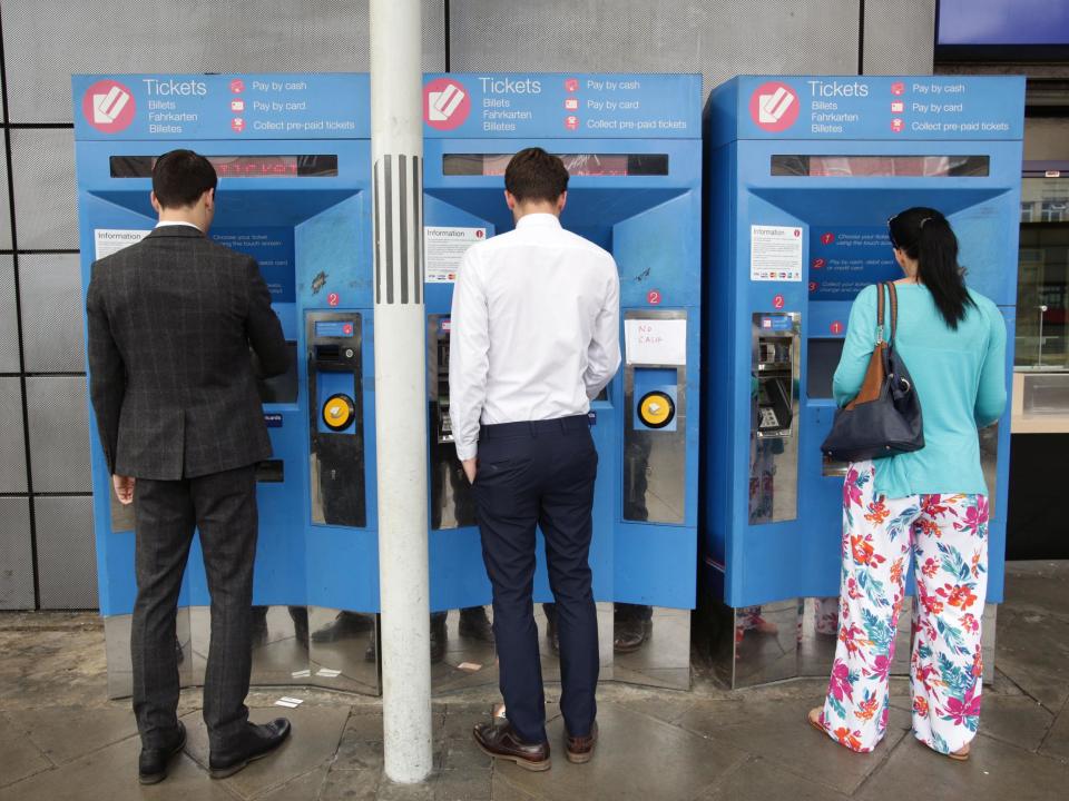 Commuters buy train tickets from machines at Finsbury Park station in north London: PA