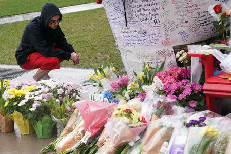 A man pays his respects at a makeshift memorial on Yonge Street following a van that attacked multiple people in Toronto, Ontario, Canada, April 25, 2018. REUTERS/Carlo Allegri