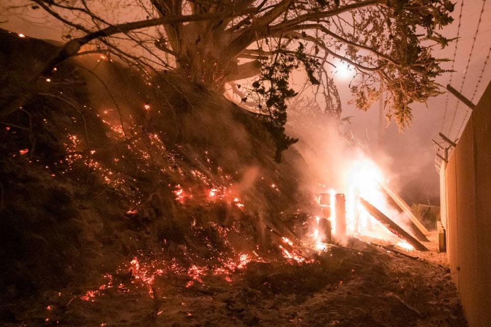 The Colorado Fire burns a fence off Highway 1 near Big Sur, Calif., Saturday, Jan. 22, 2022. (AP Photo/Nic Coury)