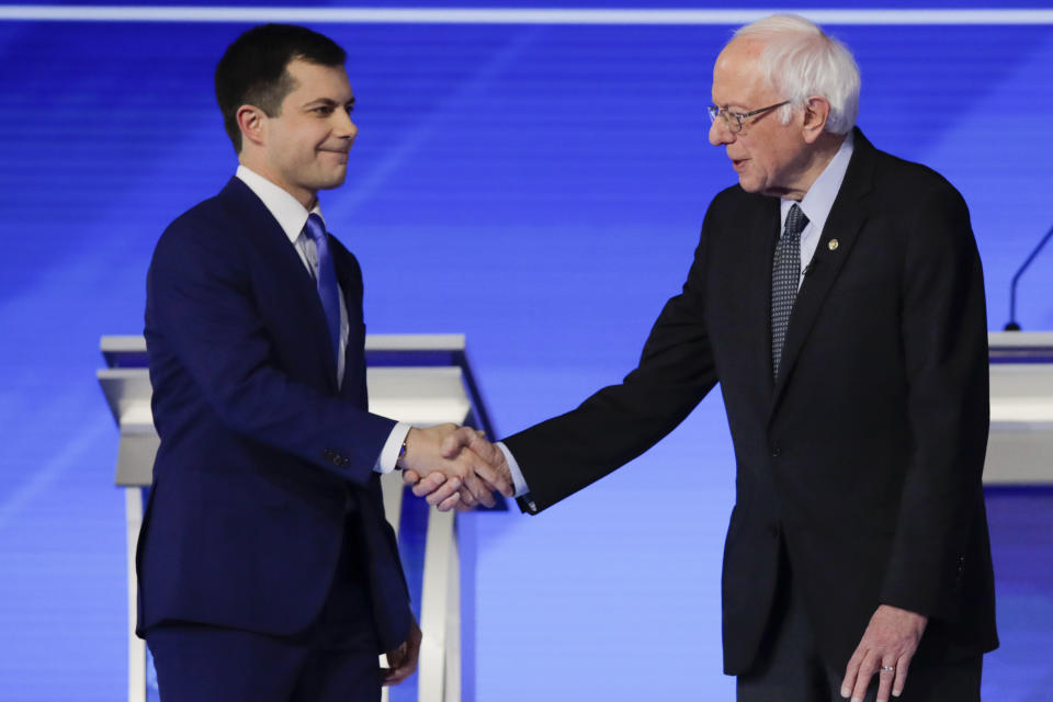 Democratic presidential candidates former South Bend Mayor Pete Buttigieg and Sen. Bernie Sanders, I-Vt., shake hands on stage Friday, Feb. 7, 2020, before the start of a Democratic presidential primary debate hosted by ABC News, Apple News, and WMUR-TV at Saint Anselm College in Manchester, N.H. (AP Photo/Charles Krupa)