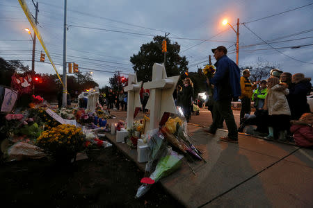 People pay their respects at a makeshift memorial outside the Tree of Life synagogue following Saturday's shooting at the synagogue in Pittsburgh, Pennsylvania, U.S., October 29, 2018. REUTERS/Cathal McNaughton