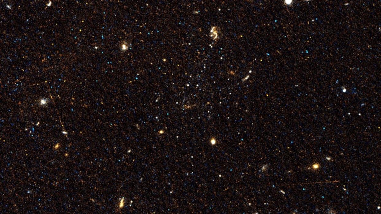  Pictured is one of the three galaxies, Scl-MM-dw5, with its stars clustered at center. 