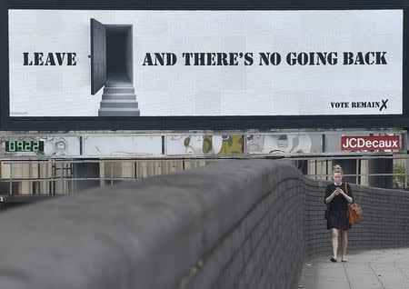 A woman walks near a 'Vote Remain' campaign electronic billboard in London, Britain June 21, 2016. REUTERS/Toby Melville