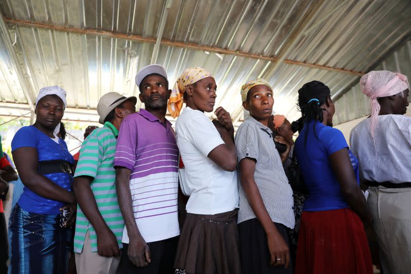 Haitians wait for money distributed by the World Food Programme in Bainet