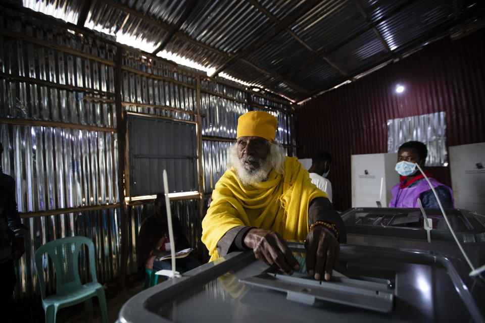 Monk Tekeste Birhan, 85, casts his vote in the general election at a polling center near Entoto Park on the outskirts of the capital Addis Ababa, Ethiopia Monday, June 21, 2021. Ethiopia began voting Monday in the greatest electoral test yet for Prime Minister Abiy Ahmed as war and logistical issues meant ballots wouldn't be cast in more than 100 of the 547 constituencies across the country. (AP Photo/Ben Curtis)