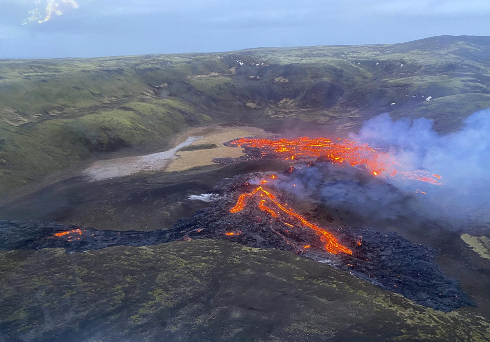 This image provided by the Icelandic Coast Guard shows a volcano on the Reykjanes Peninsula in southwestern Iceland on Saturday March 20, 2021. A long dormant volcano on the Reykjanes Peninsula flared to life Friday night, spilling lava down two sides in that area's first volcanic eruption in nearly 800 years. Initial aerial footage, posted on the Facebook page of the Icelandic Meteorological Office, showed a relatively small eruption so far, with two streams of lava running in opposite directions. (Icelandic Coast Guard via AP)