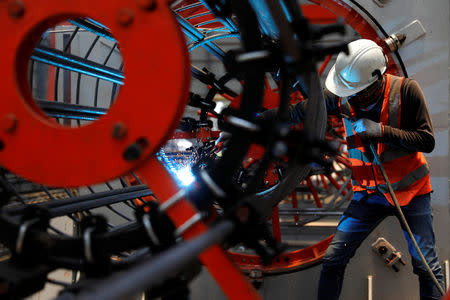 A worker welds as he installs bore-pile devices at a steel fabrication of rebar cages site for Jakarta-Bandung High Speed Railway in West Bandung regency,, West Java province, Indonesia, February 21, 2019. REUTERS/Willy Kurniawan