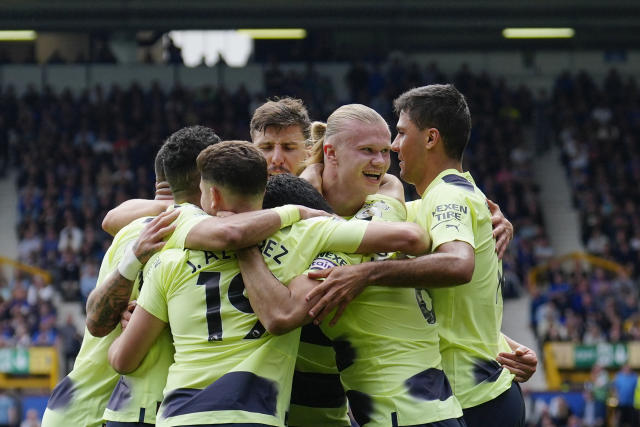 Manchester City's Erling Haaland, second from right, celebrates with teammates after scoring his side's 2nd goal during the English Premier League soccer match between Everton and Manchester City at the Goodison Park stadium in Liverpool, England, Sunday, May 14, 2023. (AP Photo/Jon Super)