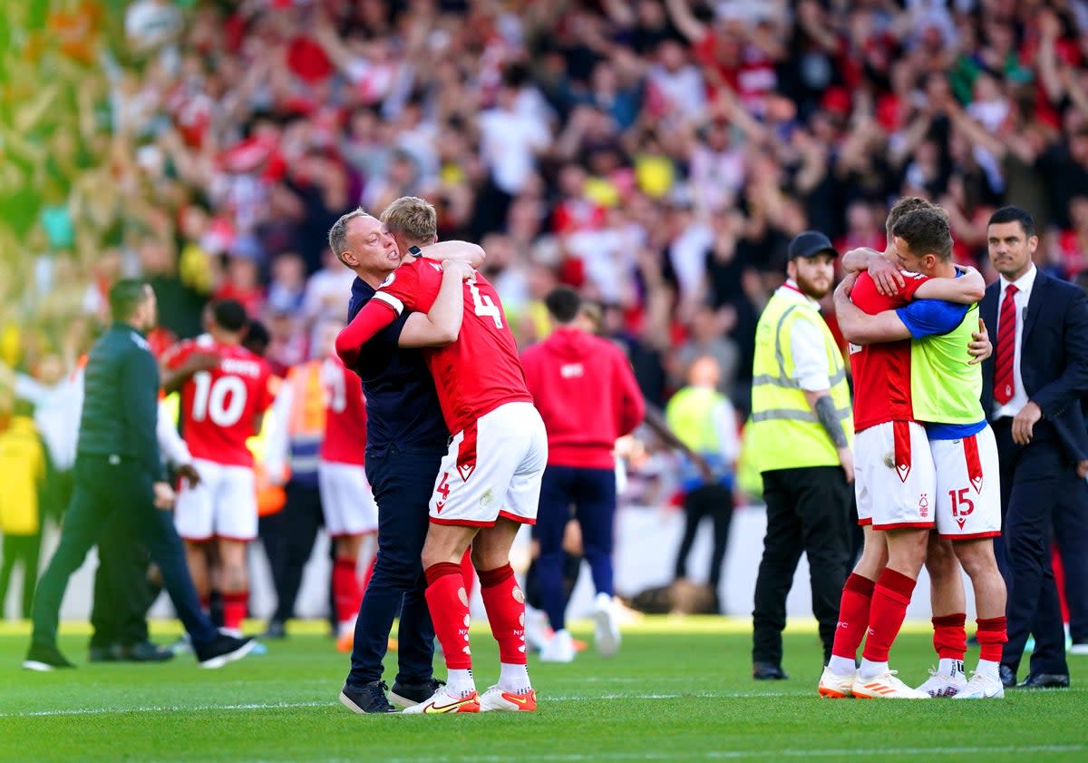 Nottingham Forest manager Steve Cooper hugs defender Joe Worrall (PA)