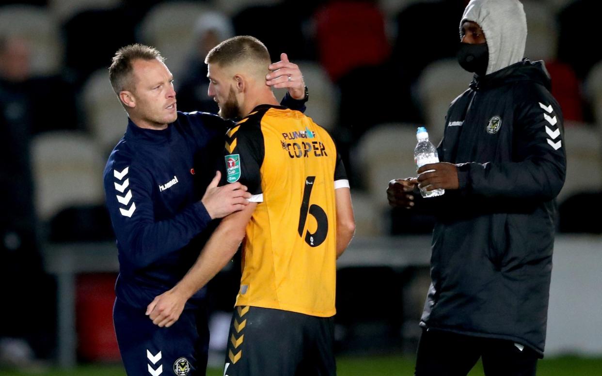 Brandon Cooper, who missed the fateful pen, is comforted by gaffer Michael Flynn  - PA / NMC Pool