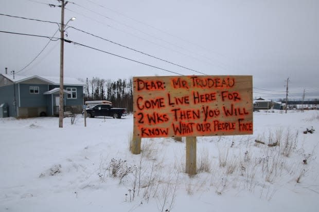 A sign in Neskantaga First Nation calls out Prime Minister Justin Trudeau for failing to end the community's 25-year-long boil water advisory.