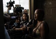 Justina Garcia, the mother of Eddy Vladimir Feliz Garcia, who was taken into custody in connection with the shooting of former Boston Red Sox slugger David Ortiz, talks to the press at court in Santo Domingo, Dominican Republic, Tuesday, June 11 , 2019. Her son's lawyer, Deivi Solano, said Féliz Garcia had no idea who he’d picked up and what was about to happen, and that he expected his client would be charged as an accomplice to an attempted murder. (AP Photo/Roberto Guzman)