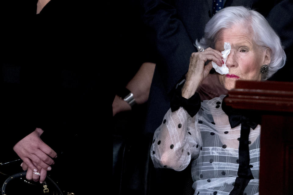 Roberta McCain, mother of the late senator, wipes her eyes as she looks at his casket.