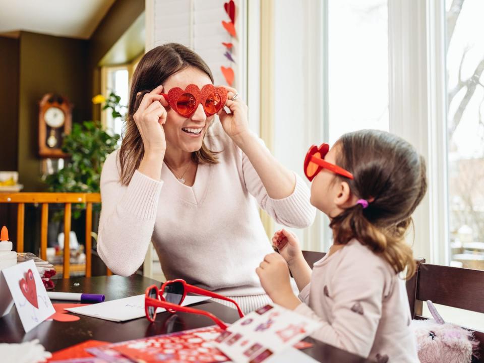 mother and young daughter crafting for valentine's day