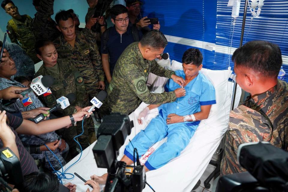 General Romeo Brawner Jr pins a medal on a sailor in Palawan province of Philippines on 19 June 2024 (Armed Forces of the Philippines)