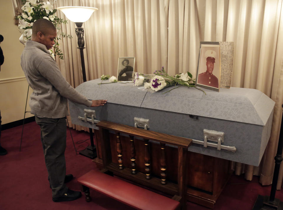 Victoria Murdough, the daughter of Jerome Murdough, touches his casket after his funeral at the Cobbs Funeral Chapel, in the Queens borough of New York, Friday, April 25, 2014. A modest family funeral was held for 56-year-old Jerome Murdough, a homeless former Marine who was found dead more than two months ago in an overheated New York City jail cell. (AP Photo/Richard Drew)